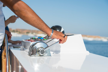 Captain at the helm yacht. Men's hand drives a yacht. concept of sea recreation and tourism