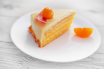 Chocolate cake with physalis fruits, cream, nuts on a plate