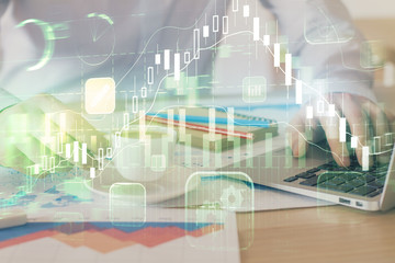 Forex graph with businessman working on computer in office on background. Concept of hardworking. Double exposure.