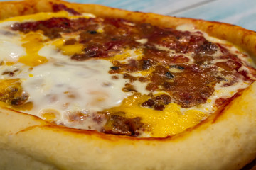 Turkish pizza on a wooden tray with rope handles