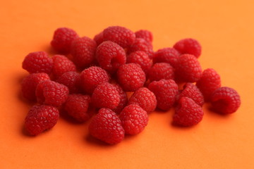 delicious raspberries in colorful background