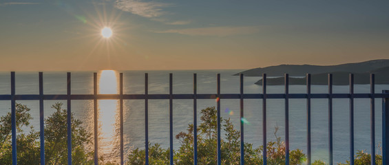 Golden sunrise sunset over the Adratic sea in Montenegro, view from the top of the Mogren Fortress in Budva.Quiet place. Relaxing scene.Calm sea water. Beautiful colors in the sky. 