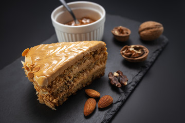 Cake with peanuts, walnuts, chocolate and caramel cream