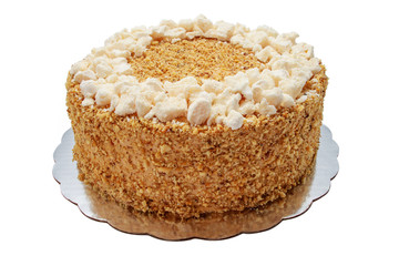 Cake piece with macaroons, chocolate, milk cream, nuts on white background