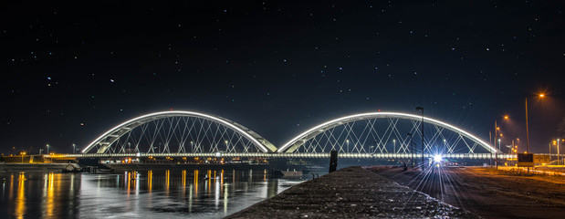 Žeželj Bridge is a tied-arch bridge on Danube river in Novi Sad, Vojvodina, Serbia. The bridge was originally built in 1961, only to be destroyed during the 1999 NATO bombing of Yugoslavia. - obrazy, fototapety, plakaty