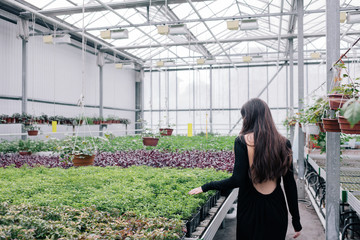 girl in a greenhouse with flowers