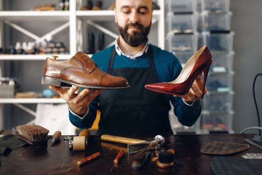 Bootmaker shows repaired shoes, footwear repair