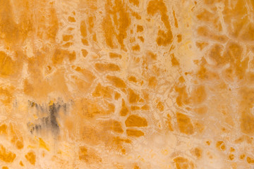 Yellow old cracked wall background. Abstract grunge wallpaper