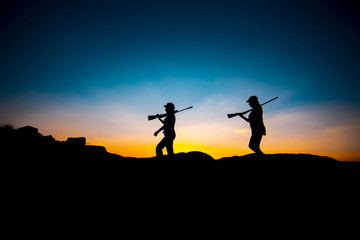Fototapeta na wymiar Hunters and rifle silhouette women