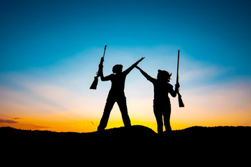 Hunters and rifle silhouette women