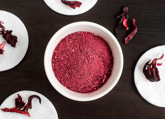 Homemade hibiscus powder for preparing face and body mask or exfoliating scrub (bath salts, foot soak). Karkade DIY beauty treatment and spa recipe. Top view, copy space © kazmulka