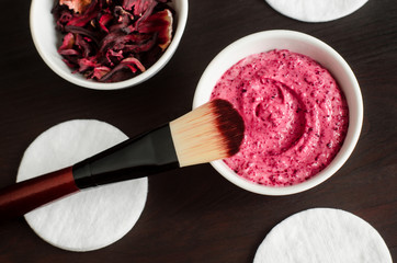 Homemade hibiscus and yogurt facial mask (body wrap, exfoliating scrub). Karkade DIY beauty treatment and spa recipe. Top view, copy space