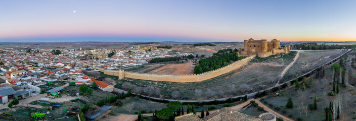 Aerial panorama view of Belmonte castle in Cuenca province Spain with long stretching city walls topped with battlements