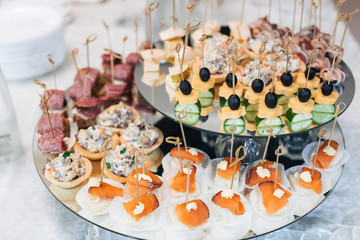 canapes with olives, cheese, cucumber and red fish and other snacks