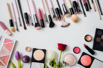 Obraz na płótnie Canvas Make up concept: Professional makeup tools and accessories. Lipstick, mascara, nail polish, eyeshadow, powder, eyelash and foundation. Top view.