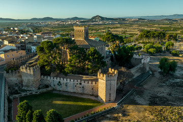 Fototapeta na wymiar Aerial morning view of fully restored Besano castle in Valencia with battlements, towers and a keep in Spain