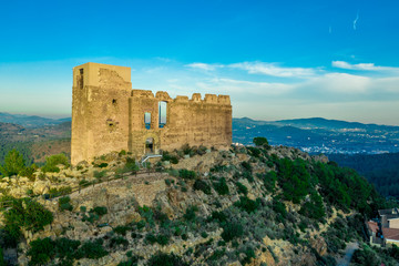 Obraz premium Aerial view of ancient ruined Gothic Beselga castle above the Peniscola Morella road with half restored keep tower and palace building supported by steel beams during sunset