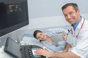 young woman undergoing ultrasound scan in clinic