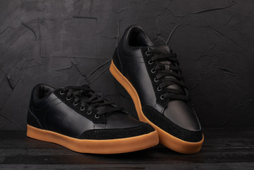 men's black sneakers on a black background