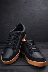 men's black sneakers on a black background