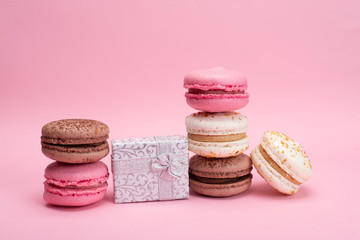 colored macaroons on a pink background