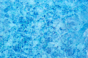 Blue swimming pool water. Water background with reflections
