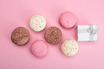 colored macaroons on a pink background