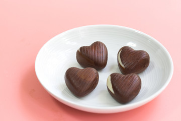 chocolate heart shape Valentine's day on pink background for texture