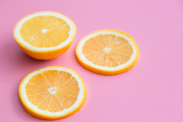 Fototapeta na wymiar Slice of fresh orange isolated on pink background view