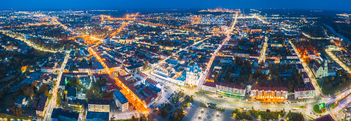 Grodno, Belarus. Night Aerial View Of Hrodna Cityscape Skyline. Popular Historic Landmark In Night Lightning. Famous Francis Xavier Cathedral. Panorama, Panoramic View