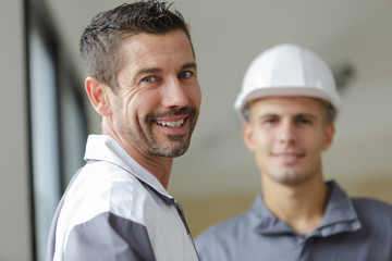 portrait of a builder in overalls and helmet on