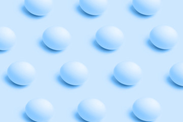 Pattern of eggs on blue color background, minimal food concept and Easter concept