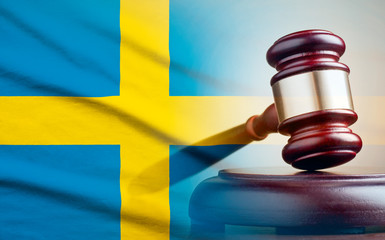 Legal gavel over a flag of the Sweden
