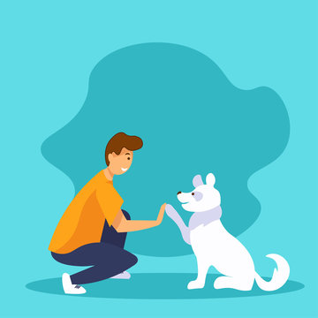 Dog and guy giving a high five. Best friends concept. Happy smiling man and funny white dog playing together. 