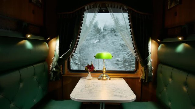 compartment in a retro train, view of the snow forest Windows