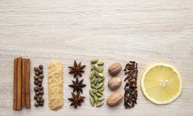 Flat Lay herbs and spices for mulled wine. Clove, cinnamon, star anise, allspice, nutmeg, cardamom, ginger, east, indian pepper.