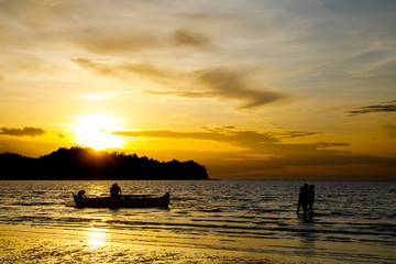 Silhouette of Pirogue and people at the Ampasy beach in Nosy Be, Madagascar