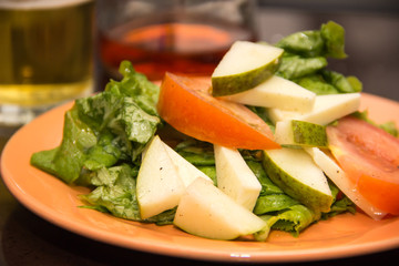 salad of tomato, mozzarella, lettuce, pear, oil