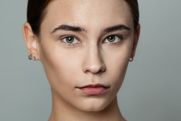Fototapeta premium Young beautiful woman without makeup cosmetics portrait. Face closeup, real skin