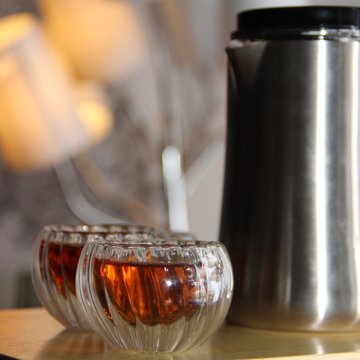 Metal kettle and black tea in chinese glass piala