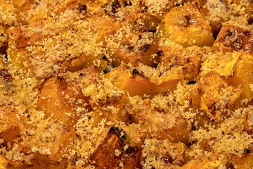 The surface of fresh baked pumpkin with honey and chopped nuts