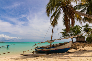 Priogue of local Fishermen under palms on paradise island Nosy Iranja, Madagascar