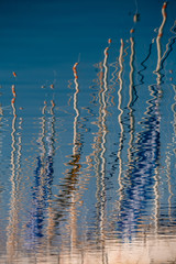 Water reflection of sailing mast