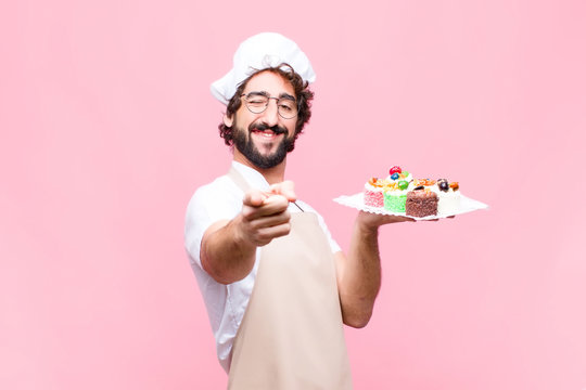 Young Crazy Baker Man Confectionery Concept Against Pink Wall