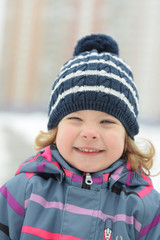 beautiful little girl in a hat with a boumbon smiles