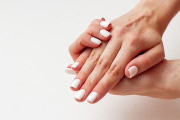 gentle female hands with a beautiful gel polish manicure