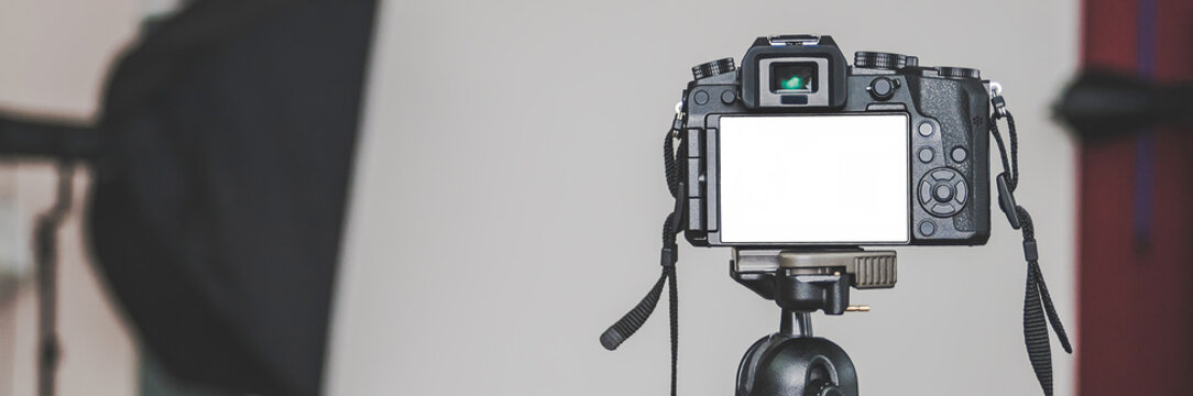 Banner, Mock up of a professional camera, in a photo studio, against the background of softbox light sources.