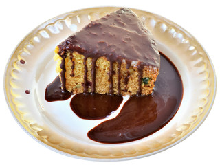 Sponge cake with chocolate icing on a plate isolated