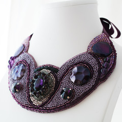 colored handmade jewelry made of beads, stones and metal on a white background