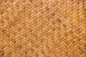 pattern of brown woven reed mat texture background, basketry crafted by Thai people.